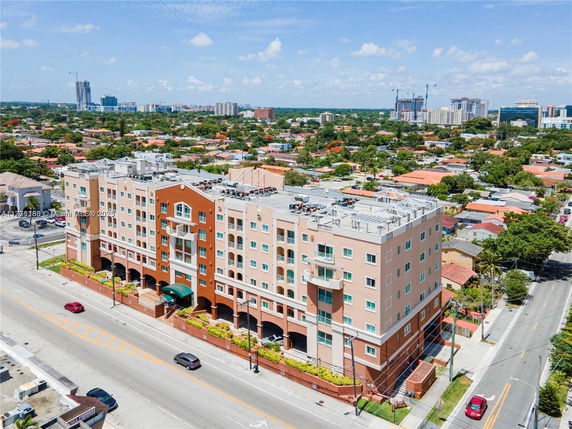 Front view of a mid-rise commercial building with multiple stories and decorative architectural elements.