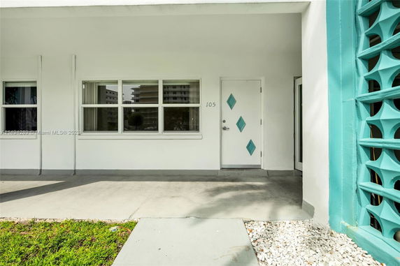 Front view of a single-story building with a unique door design.