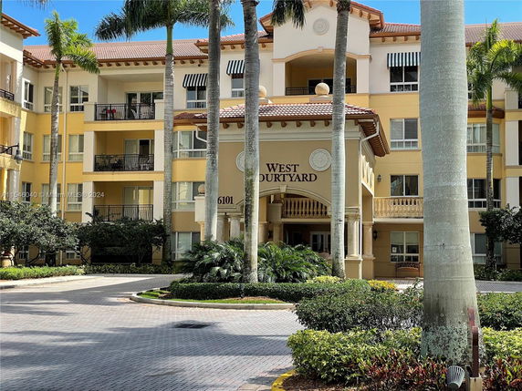 Front view of a multi-story building with balconies and an entrance labeled 'West Courtyard'.
