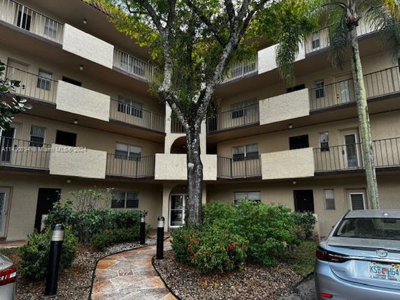 Front view of a multi-story residential building with balconies.