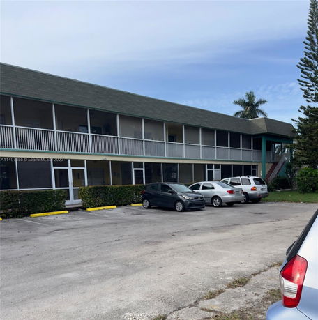 Front view of a two-story building with parking spaces in front.