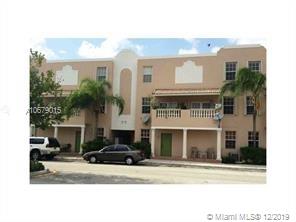 Front view of a multi-story apartment building with balconies.