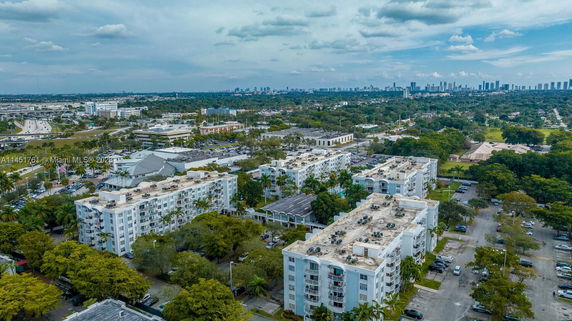 Aerial view of multiple mid-rise buildings and surrounding urban landscape.