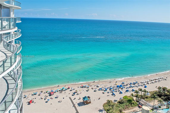Panoramic view from a building overlooking a beach and ocean.