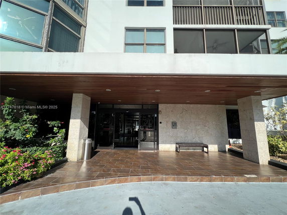 Front view of a multi-story building with an entrance area.