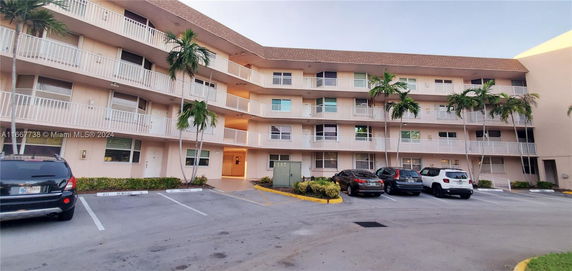 Front view of a multi-story residential building with balconies.