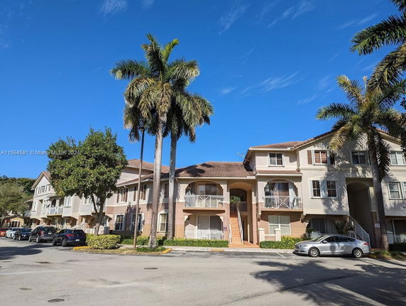 Front view of a multi-story residential building with balconies.