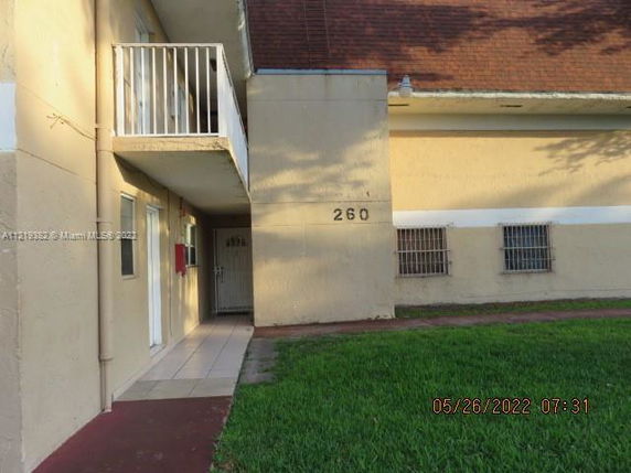 Side view of a building with a small balcony and a walkway.