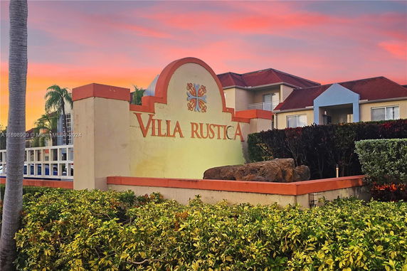 Front view of Villa Rustica building with landscaping.