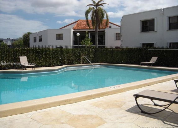 Outdoor area featuring a swimming pool with surrounding lounge chairs.