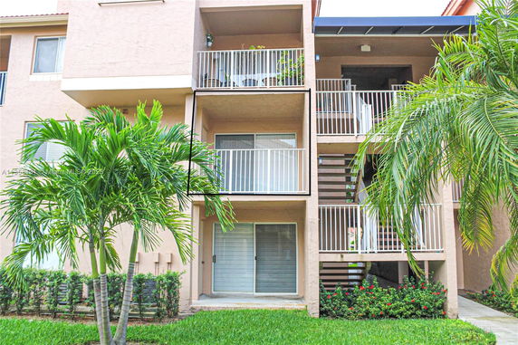 Front view of a multi-story residential building with balconies.