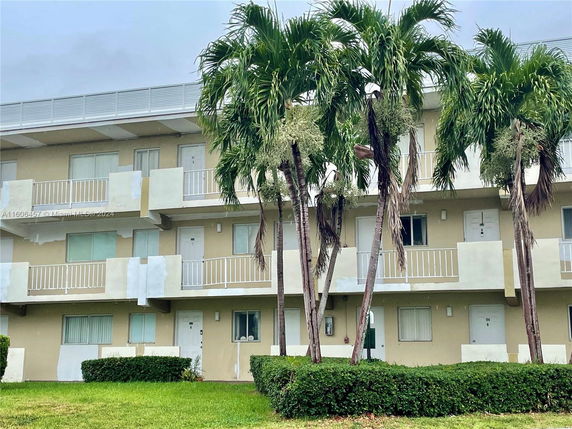 Front view of a three-story building with balconies.