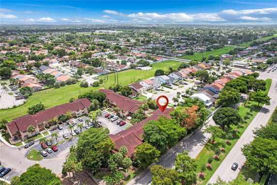Aerial view of a suburban neighborhood with multiple residential buildings and houses.