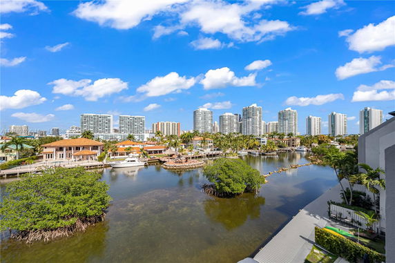 View of waterway with residential buildings and high-rise structures in the background.