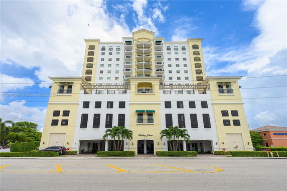 Front view of a multi-story residential building with balconies.