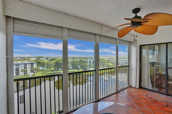 Balcony view showing nearby buildings and a body of water.