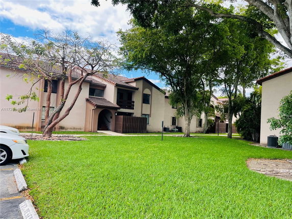 Front view of a two-story residential building with a tile roof.