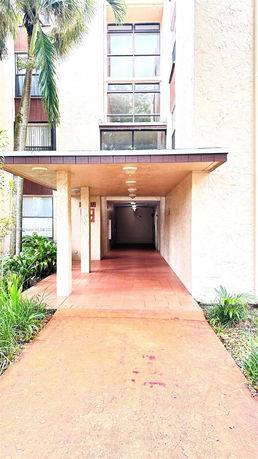 Front view of a building with a covered entrance passage.