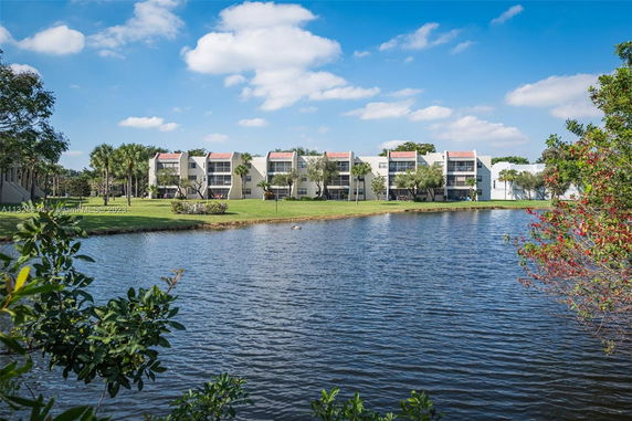 View of residential buildings across a body of water.