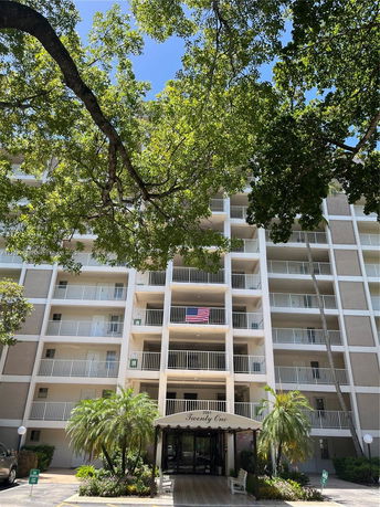 Front view of a multi-story residential building with balconies.