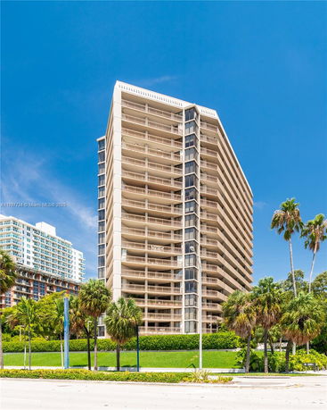 Front view of a multi-story residential building with balconies.