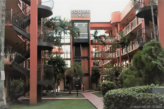 View of a multi-story building with spiral staircases and balconies.