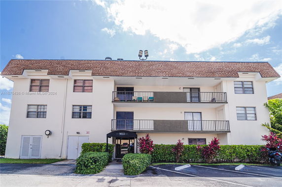Front view of a three-story residential building with balconies.