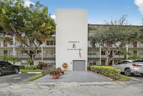 Front view of a multi-story residential building with a central entrance.