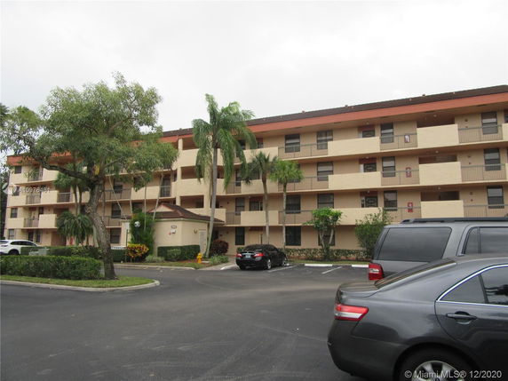 Front view of a multi-story residential building with balconies.