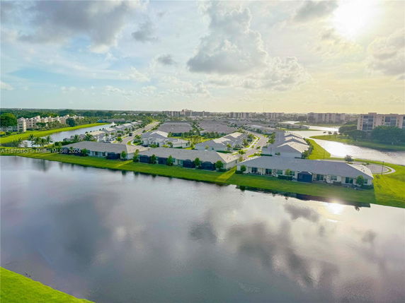 Aerial view of residential buildings near a body of water.