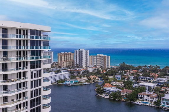 Panoramic view of city buildings and ocean.