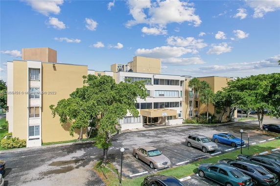 Front view of a multi-story building with a parking area.