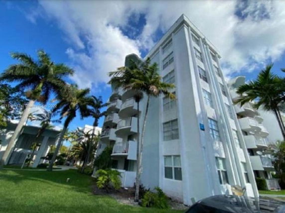 Front view of a multi-story residential building with balconies.