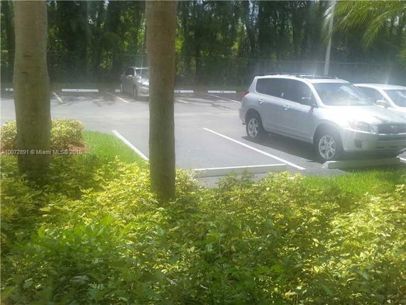 Outdoor parking area with parked cars.