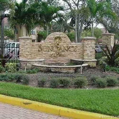 Exterior view of a stone entrance sign for a residential area named Sundance.