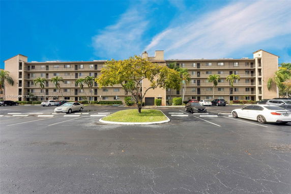 Front view of a multi-story residential building with balconies.
