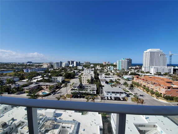 Panoramic view of a city skyline with various buildings, seen from a high vantage point.