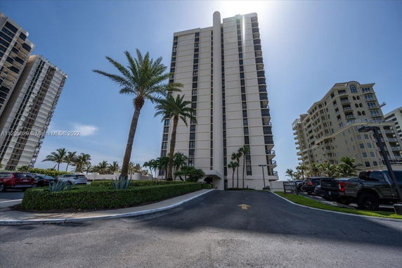 Front view of a tall residential apartment building with balconies.