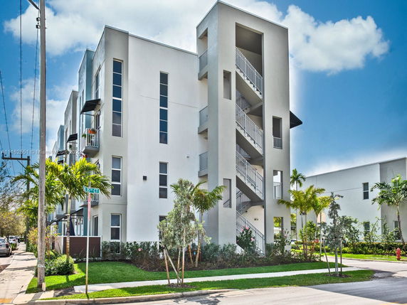 Front view of a modern multi-story building with outdoor staircases.