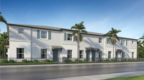Front view of a two-story residential building with a white exterior and palm trees in front.