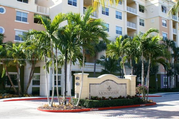 Front view of a multi-story residential building with balconies.