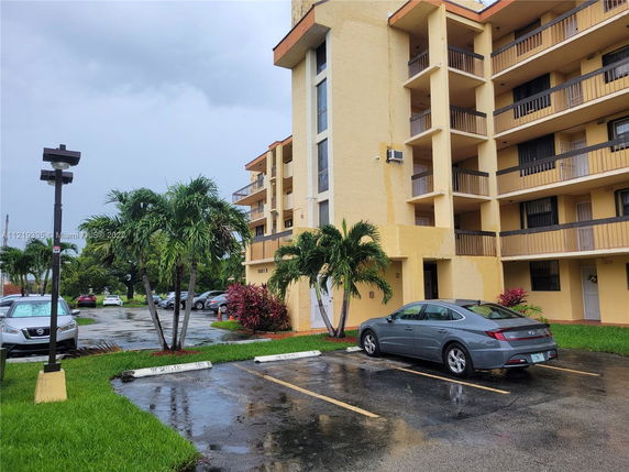 Front view of a multi-story residential building with balconies.