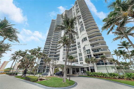 Front view of a tall residential building with balconies.