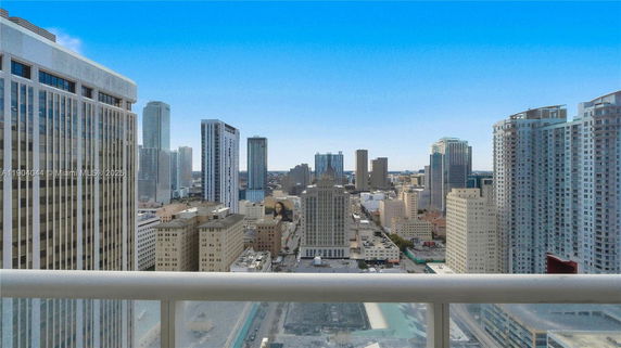 Panoramic view from a high-rise building showing a cityscape with multiple skyscrapers.