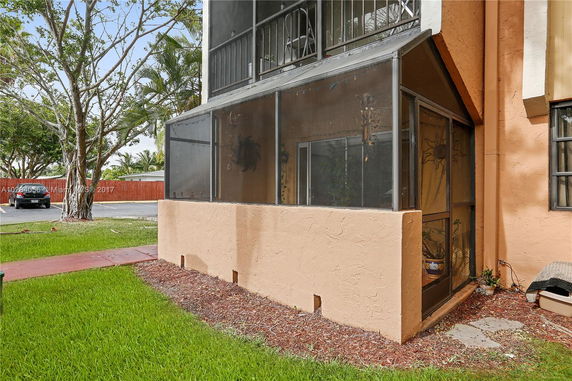 Front view of a building with a screened patio.