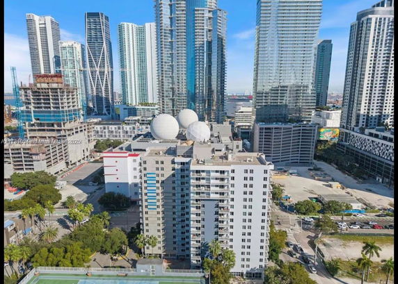 View of tall modern skyscrapers in an urban area with various towers and buildings.