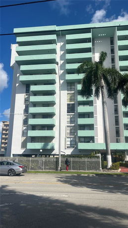 Front view of a multi-story building with balconies.
