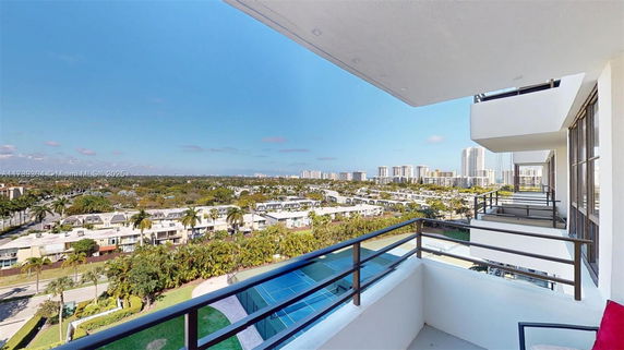 Panoramic view from a high-rise building balcony showcasing surrounding residential and commercial buildings.