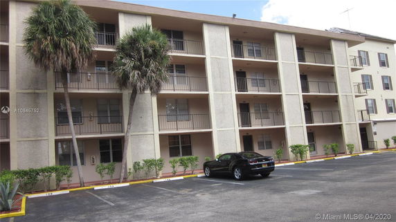Front view of a multi-story apartment building with balconies.