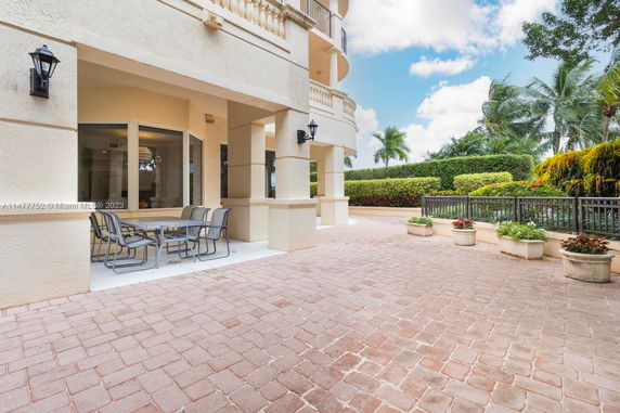 Front view of a building with a patio area and outdoor seating.